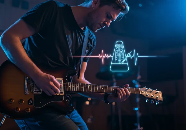 Musician with guitar using an online metronome for rhythm